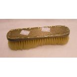 A silver backed clothes brush