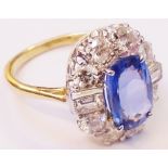 A 18ct. gold ring, set with central 3.15ct. oval sapphire within a diamond encrusted border with