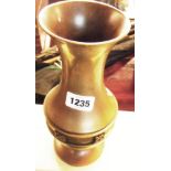 A 10 1/2" bulbous bronze vase with flared rim