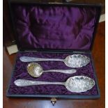 A cased pair of silver plated berry spoons and sifter spoon to match