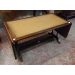 A 35" 20th Century stained wood drop-leaf coffee table with leather inset top, flanking turned
