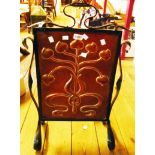 An early 20th Century copper fire screen with embossed floral motif within a decorative wrought iron