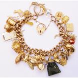 A 9ct. gold kerb-link charm bracelet set with numerous 9ct. and yellow metal charms, heart shaped