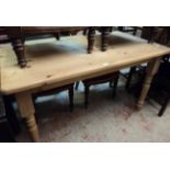 A 4' 6" 20th Century stripped pine kitchen table, set on turned legs