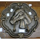 A reproduction cast metal coat rack with horse head bracket