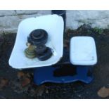 A set of kitchen scales with enamelled pans and a selection of weights