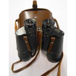 A leather cased pair of vintage Nikon 7X50 binoculars