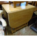 A limed oak and mixed wood gateleg table, set on turned supports