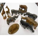 A box containing a collection of carved wood animals including a pair of lions, pair of rhinos, pair