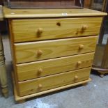 A 32" modern waxed pine chest of four long drawers, set on turned feet
