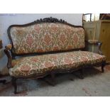 A 5' 8" Victorian rosewood part show frame settee with carved acanthus scroll and floral