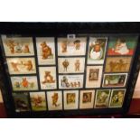 A collection of twenty early 20th Century Teddy bear postcards contained within a carved wood frame