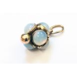 An antique yellow metal bauble pendant, set with six cabochon moonstones and spherical terminal