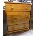 A 29" modern waxed pine chest of four long graduated drawers, set on bracket feet