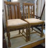 A set of four 20th Century oak framed lath back dining chairs with upholstered drop-in seats, set on