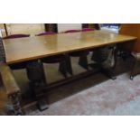 A 5' 11 1/2" 20th Century polished oak refectory dining table, set on massive bulbous and carved