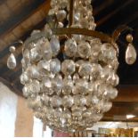 A gilt metal basket pendant ceiling light with two tiers of faceted glass lustres