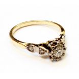 A marked 18ct. yellow metal Art Deco ring, set with central small diamond and four smaller stones to