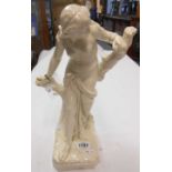 A 15" high late 19th-early 20th Century white glazed porcelain semi-nude figure holding a tree, "The