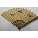 An early 20th Century fan with simulated ivory sticks and painted swallow decoration