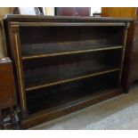 A 4' 1 1/2" early 20th Century quarter sawn stained oak and parcel gilt three shelf open bookcase,