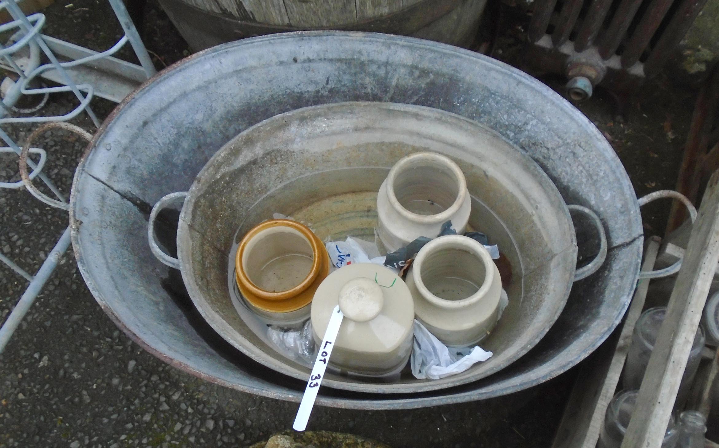 Two galvanised tin baths - sold with a grey stoneware hot water bottle and three stoneware jars