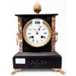 A late Victorian black slate and marble cased mantel clock with ornate gilt metal handles and Japy