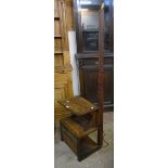 A 20th Century oak combined standard lamp/side table with shelf, recess and open base