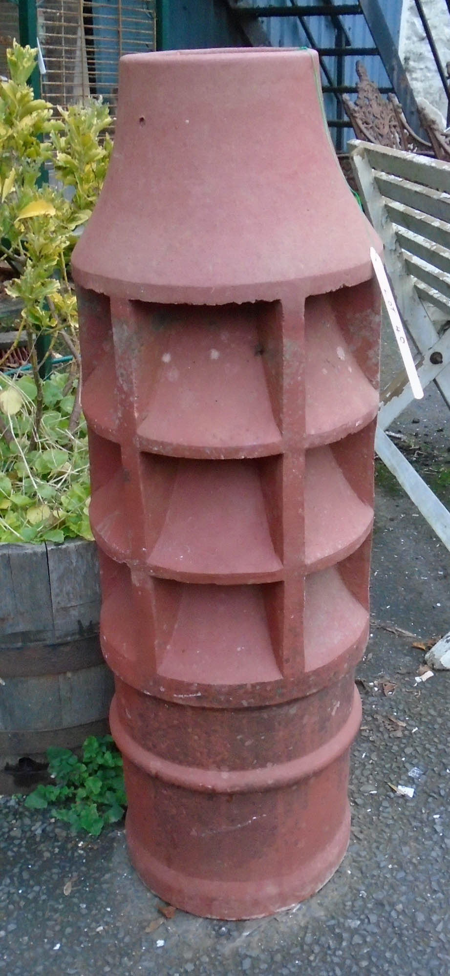 A 3' 3" terracotta chimney pot with vented sides