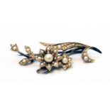 An early 20th Century yellow metal seed pearl encrusted floral pattern brooch
