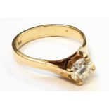 A marked 750 yellow metal 0.62ct diamond solitaire ring - with copy of the valuation certificate