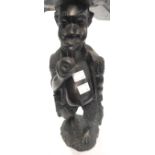 A 15" high African carved rosewood figure of a man smoking a pipe