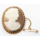 A 9ct. gold framed oval cameo brooch with safety chain