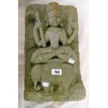 An Indian stone carving of the bodhisattva Samantabhadra holding a vajra and a trishula while sat in