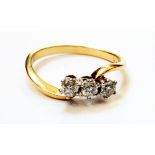 An 18ct. gold three stone diamond cross-over ring - 0.33ct. TDW