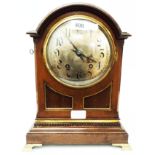 A late 19th Century walnut cased dome top table clock with silvered dial, Arabic numerals and