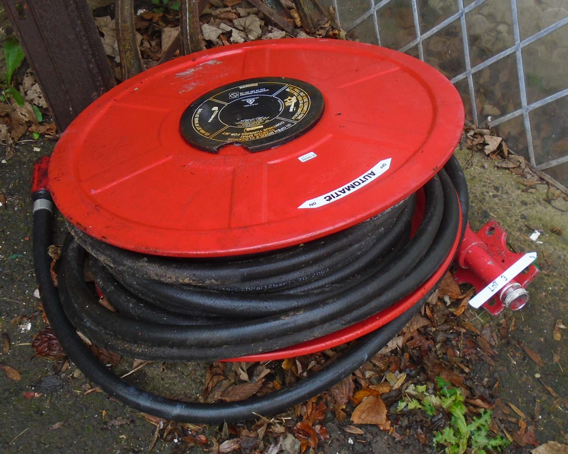 A wall mounted fire hose on reel