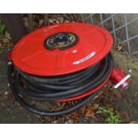 A wall mounted fire hose on reel