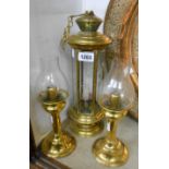 A pair of brass candlesticks with glass shades - sold with a faceted brass lantern