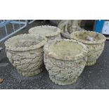 A set of four cast concrete planters with oak leaf decoration