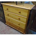 A 32" modern pine chest of four long graduated drawers, set on turned feet