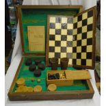 An oak games box with chess and draughts pieces