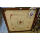 A Carrom board with boxed playing pieces