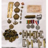 A small collection of First and Second World War badges, buttons, medals, and other items of