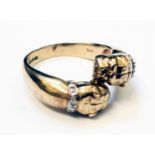 A 9ct. gold gentleman's ring with two cast bulldog heads with tiny diamond encrusted collars to