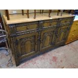 A 5' 20th Century carved and moulded oak sideboard with three frieze drawers and triple decorative