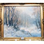 An ornate gilt framed oil on canvas depicting a snowy wooded landscape - indistinctly signed - 19