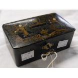 An antique Oriental papier-mâché lockable money box with gilt painted scene to lid and key