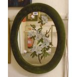 A 22" green velvet clad oval wall mirror with painted floral decoration to plate