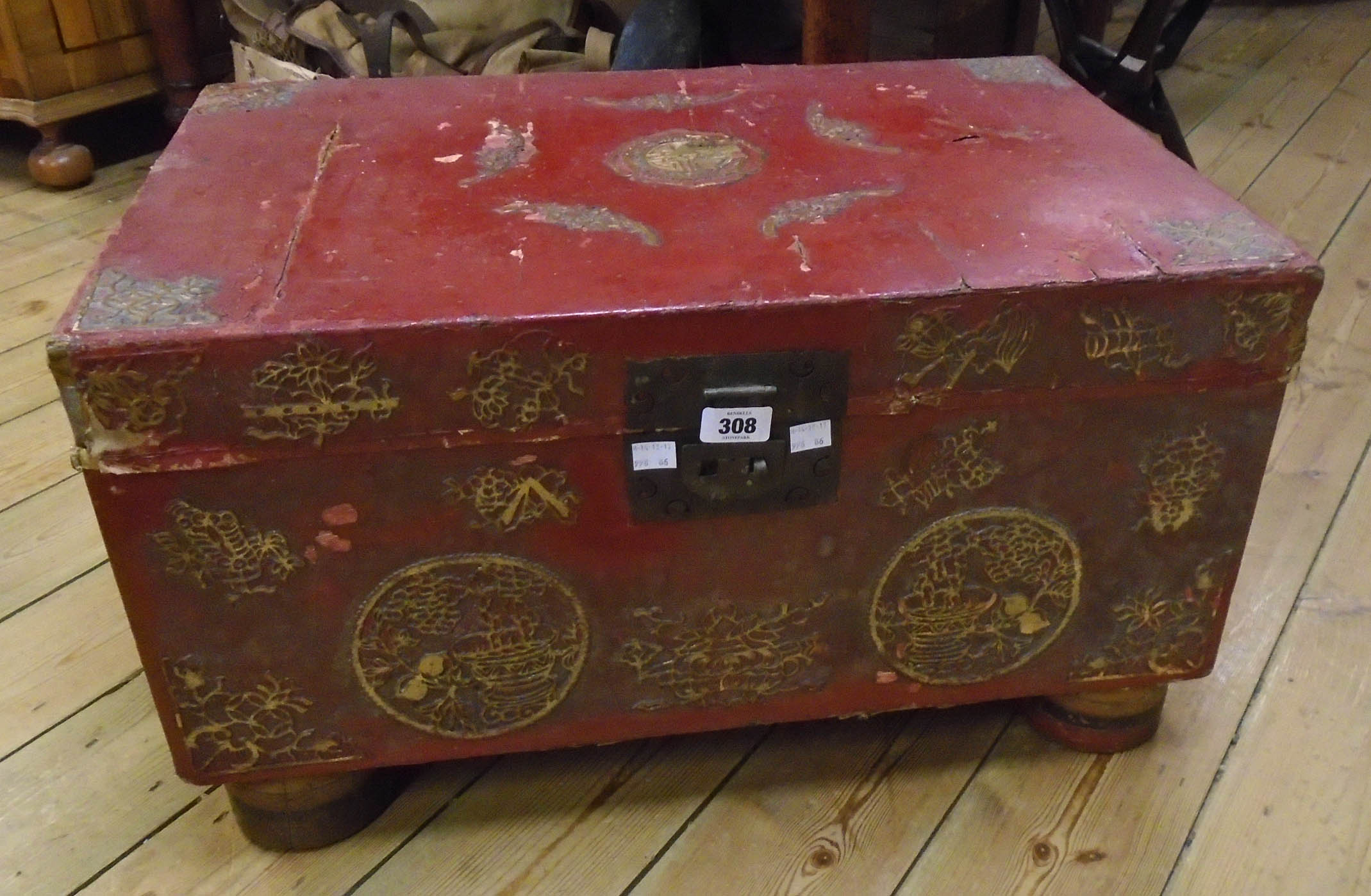 A 26" oriental red lacquered and parcel gilt decorated lift-top box with metal latch and